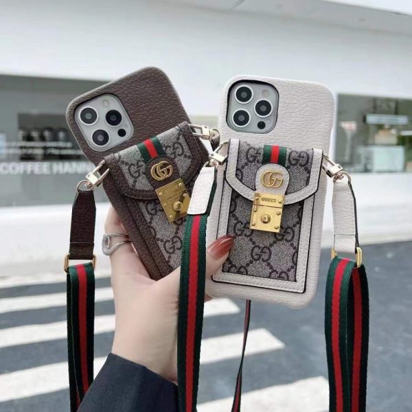 Hand holding the sleek Gucci iPhone case with card holder