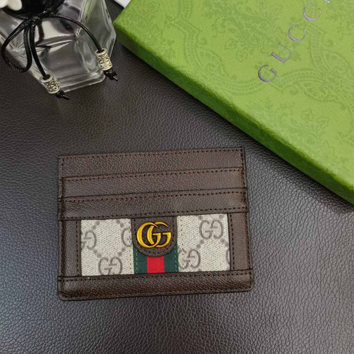 Close-up of Gucci logo on card holder wallet