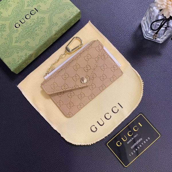 Gucci Signature Leather Wallet & Card Holder next to luxury accessories
