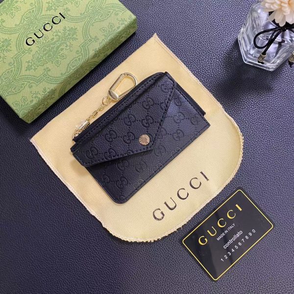 Holding the Gucci Signature Leather Wallet & Card Holder showcasing its elegant design